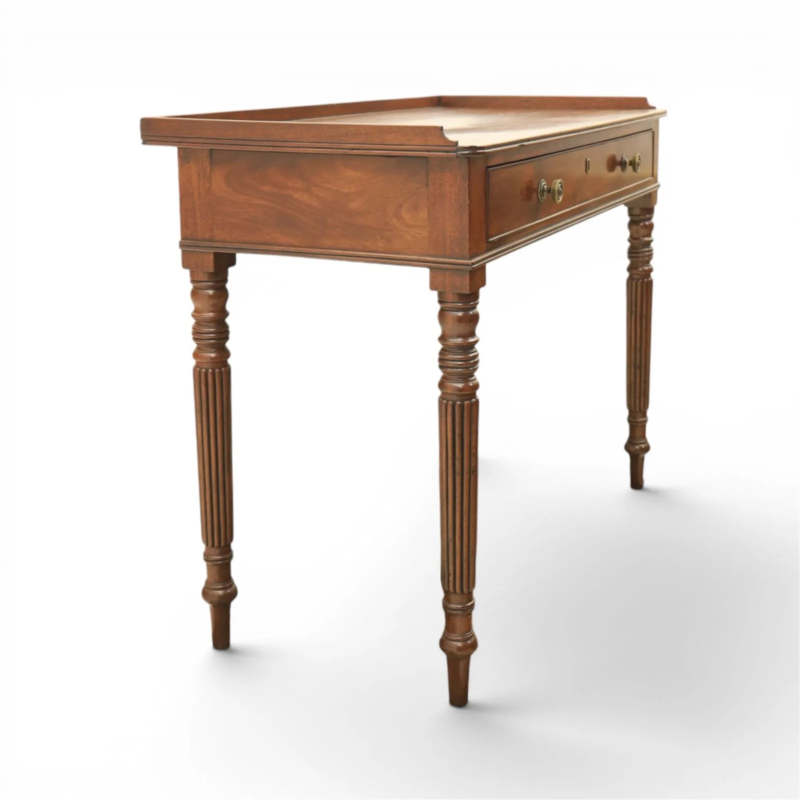 Regency English mahogany dressing table, stamped Gillow, early 19th century; rectangular top with three-quarter gallery above a frieze drawer with twin brass knobs; raised on turned and reeded supports thumbnail 2