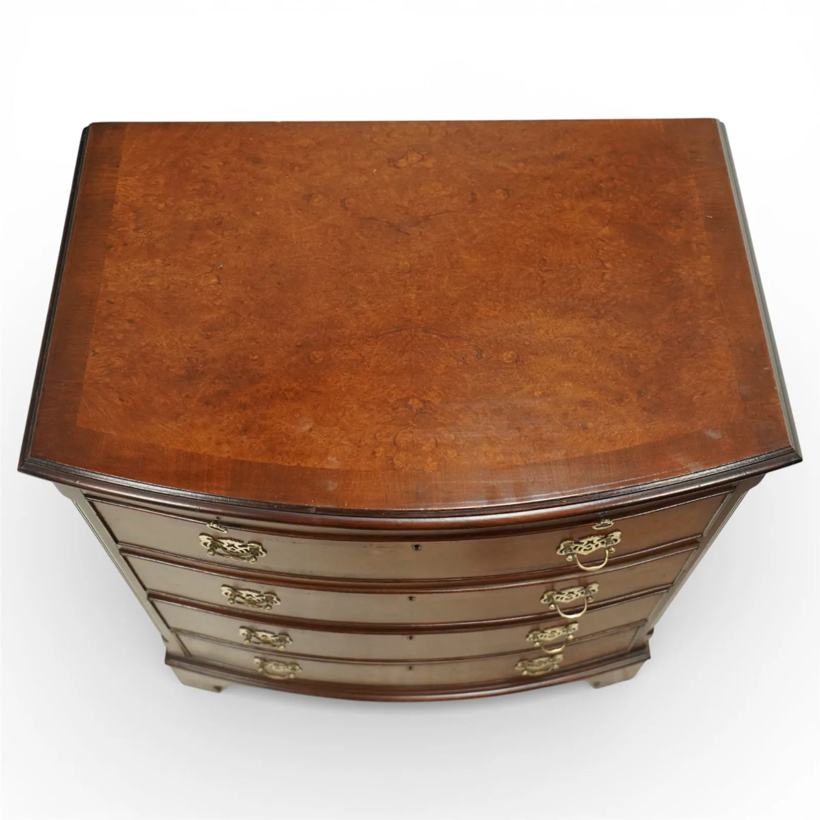 20th century Queen Anne style burr walnut bow fronted chest of drawers, moulded rectangular top above a brushing slide, four graduated drawers fitted with pierced brass handles, flanked by canted corners, raised on shaped bracket feet thumbnail 4