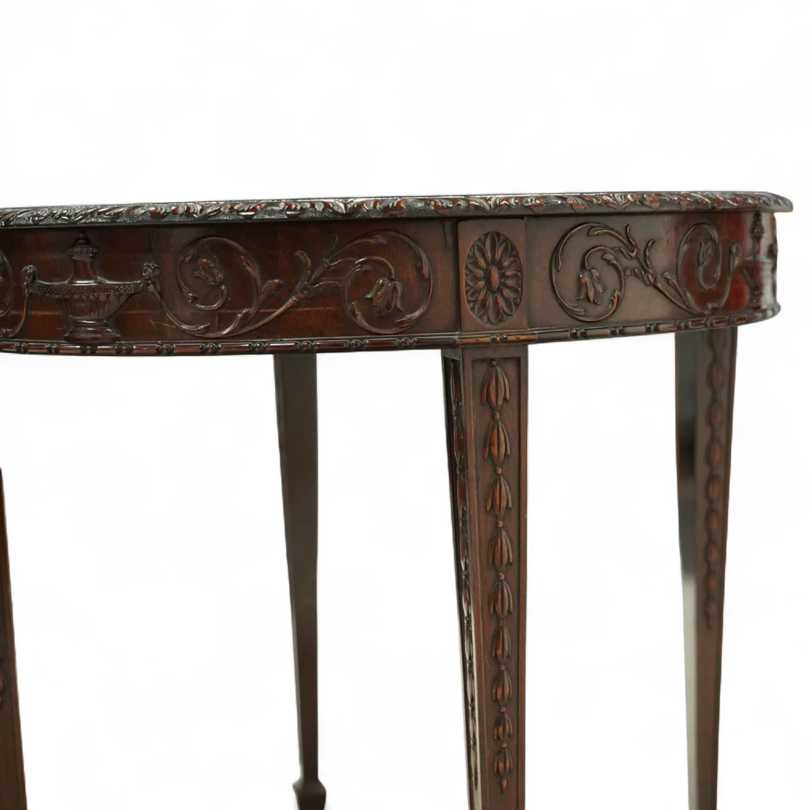 Early 20th-century Adam style mahogany circular centre table; moulded frieze carved with scrolling foliage, urns and rosettes; square tapering legs with husk carving, terminating in spade feet thumbnail 3
