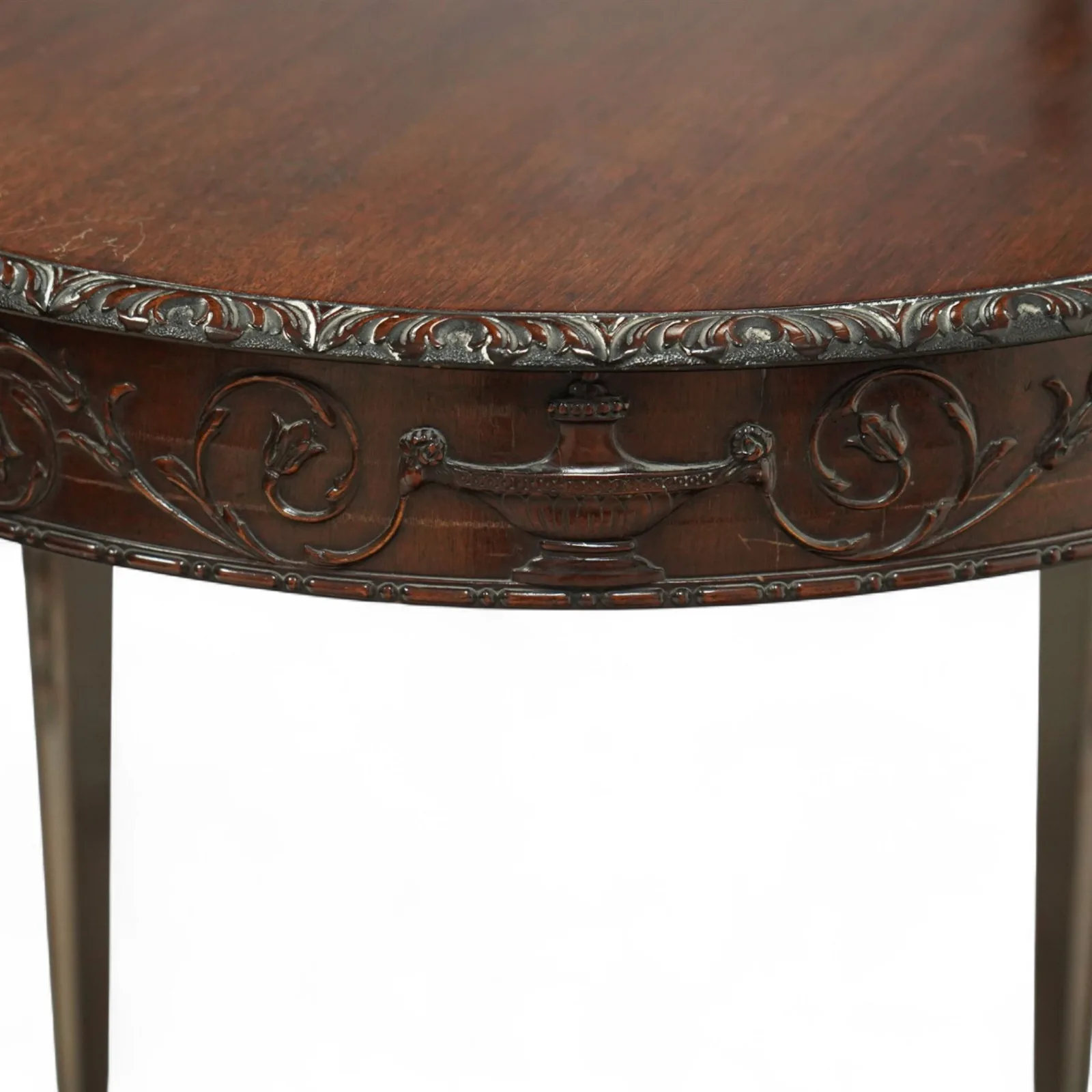 Early 20th-century Adam style mahogany circular centre table; moulded frieze carved with scrolling foliage, urns and rosettes; square tapering legs with husk carving, terminating in spade feet thumbnail 2