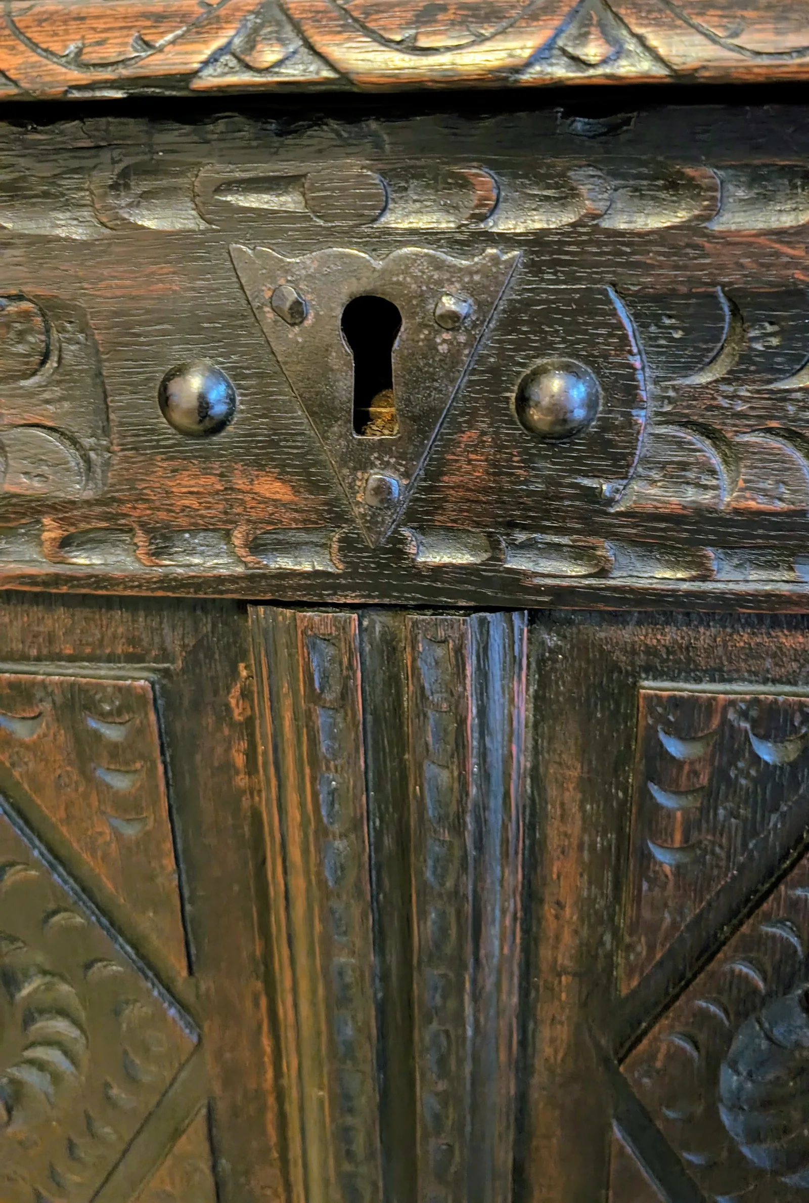 19th-century carved oak coffer; rectangular plank top over a four-panel front with lozenge and flowerhead carving, shaped lower apron, stile feet; sturdy provincial work thumbnail 15