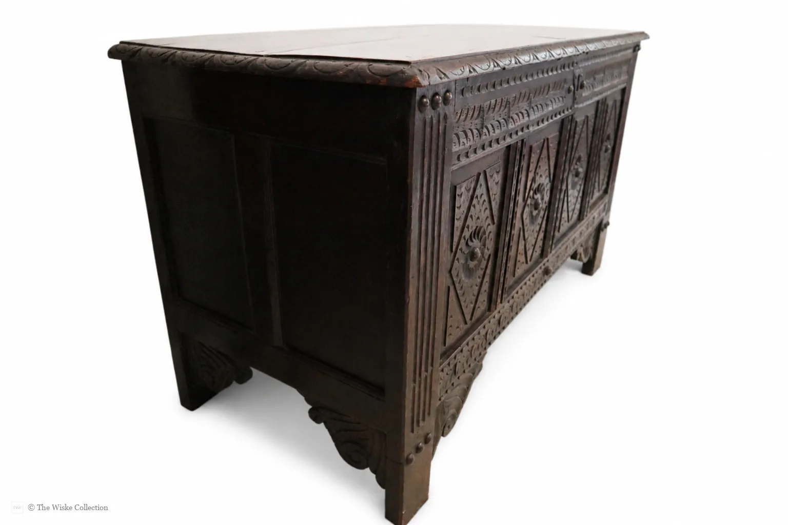 19th-century carved oak coffer; rectangular plank top over a four-panel front with lozenge and flowerhead carving, shaped lower apron, stile feet; sturdy provincial work thumbnail 4