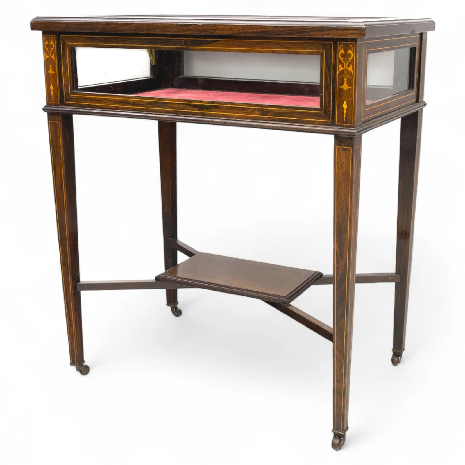 Edwardian rosewood bijouterie cabinet, the hinged rectangular top with line inlay enclosing a velvet lined interior, upon slender tapering legs inlaid with satinwood foliate marquetry decoration, with stretchers united by an under tier, raised on castors thumbnail 3