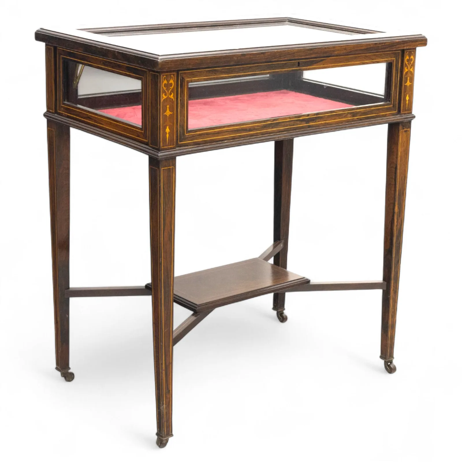 Edwardian rosewood bijouterie cabinet, the hinged rectangular top with line inlay enclosing a velvet lined interior, upon slender tapering legs inlaid with satinwood foliate marquetry decoration, with stretchers united by an under tier, raised on castors thumbnail 2
