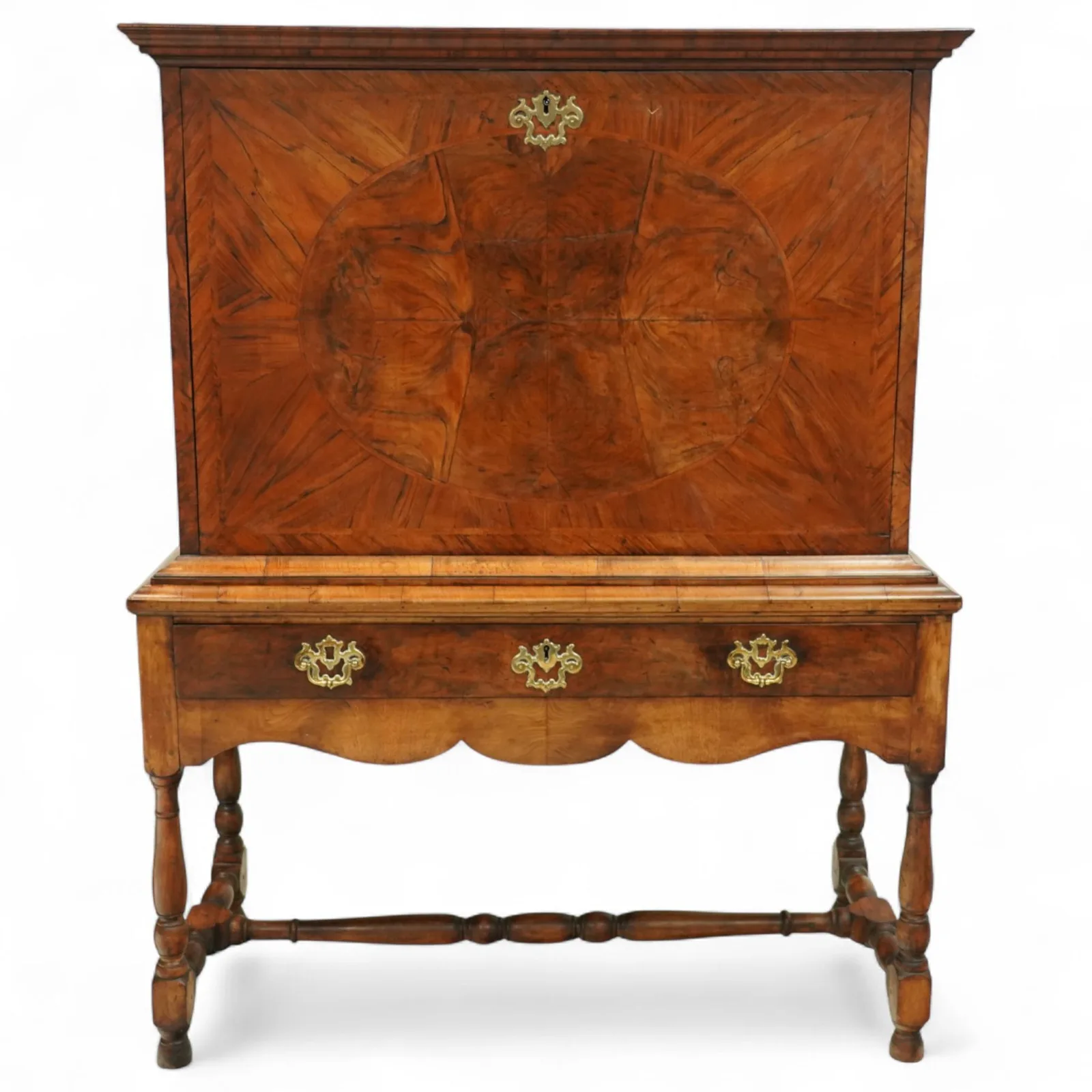 George I walnut bureau cabinet, early 18th century; moulded cornice, fall-front inlaid with oval burr-walnut panel, fitted drawers, pigeonholes and cupboard; baize-lined writing surface above long drawer; apron, turned legs and stretcher; later stand with brass strut supports; lacking key - Plate 1