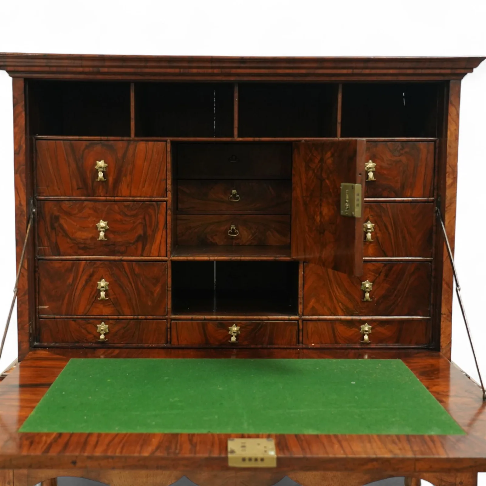 George I walnut bureau cabinet, early 18th century; moulded cornice, fall-front inlaid with oval burr-walnut panel, fitted drawers, pigeonholes and cupboard; baize-lined writing surface above long drawer; apron, turned legs and stretcher; later stand with brass strut supports; lacking key thumbnail 6
