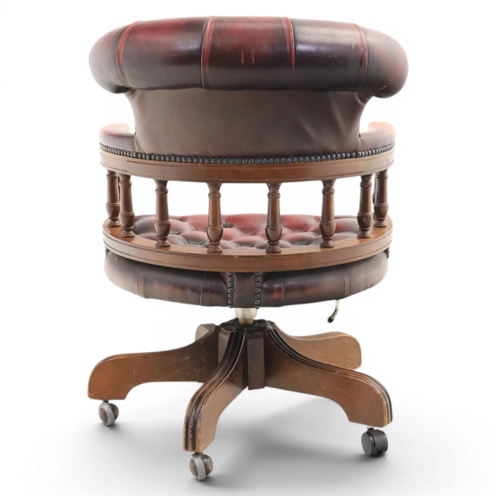 Captains swivel desk chair upholstered in oxblood leather, buttoned back and seat, shaped arm bow raised on turned spindles, five spoke base raised on castors thumbnail 6