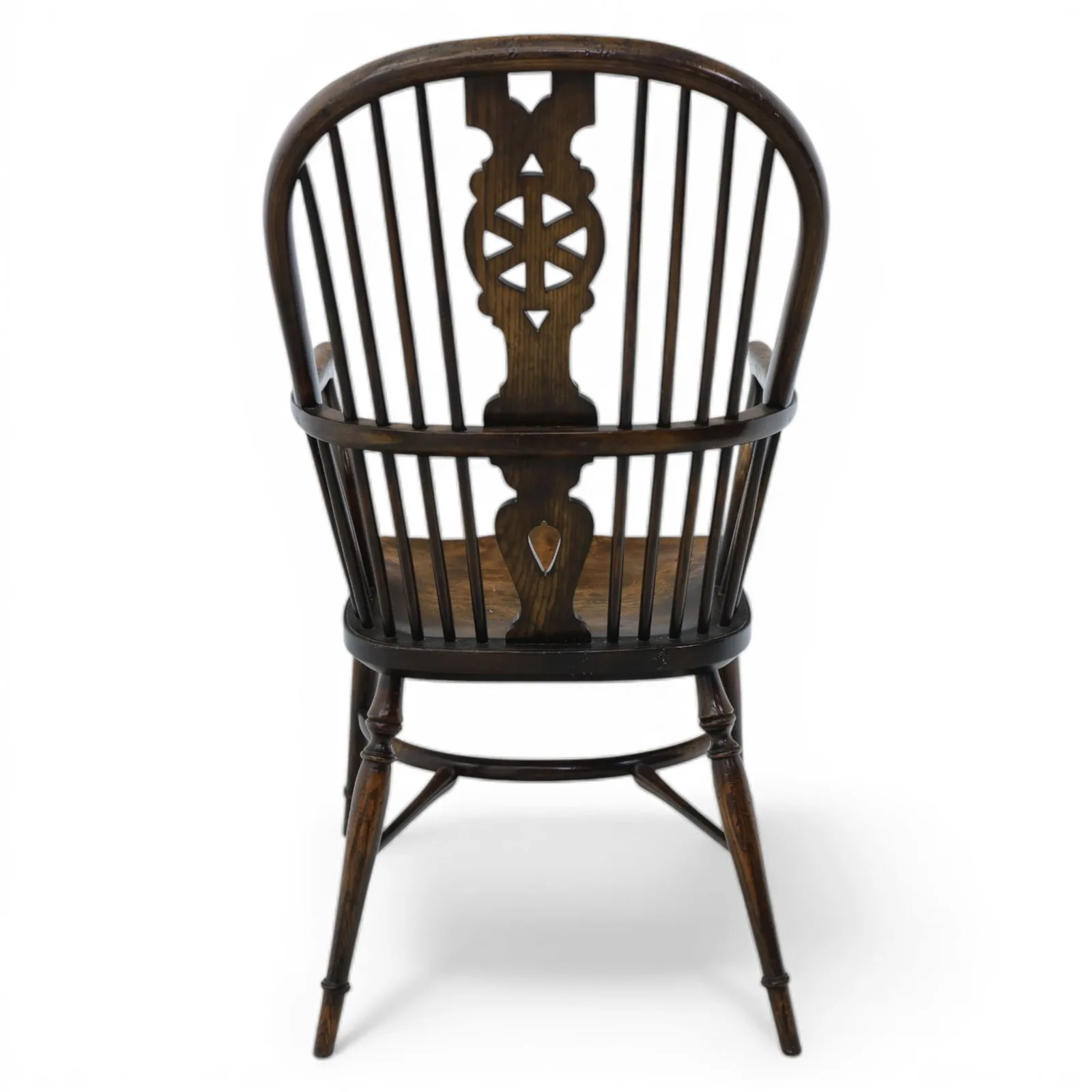 Late 19th-century Edwardian English high-back Windsor armchair in elm and beech, the arched hoop back with pierced wheel and heart motifs, turned spindles and shaped arm rail, saddle seat, on turned legs joined by a crinoline stretcher thumbnail 5