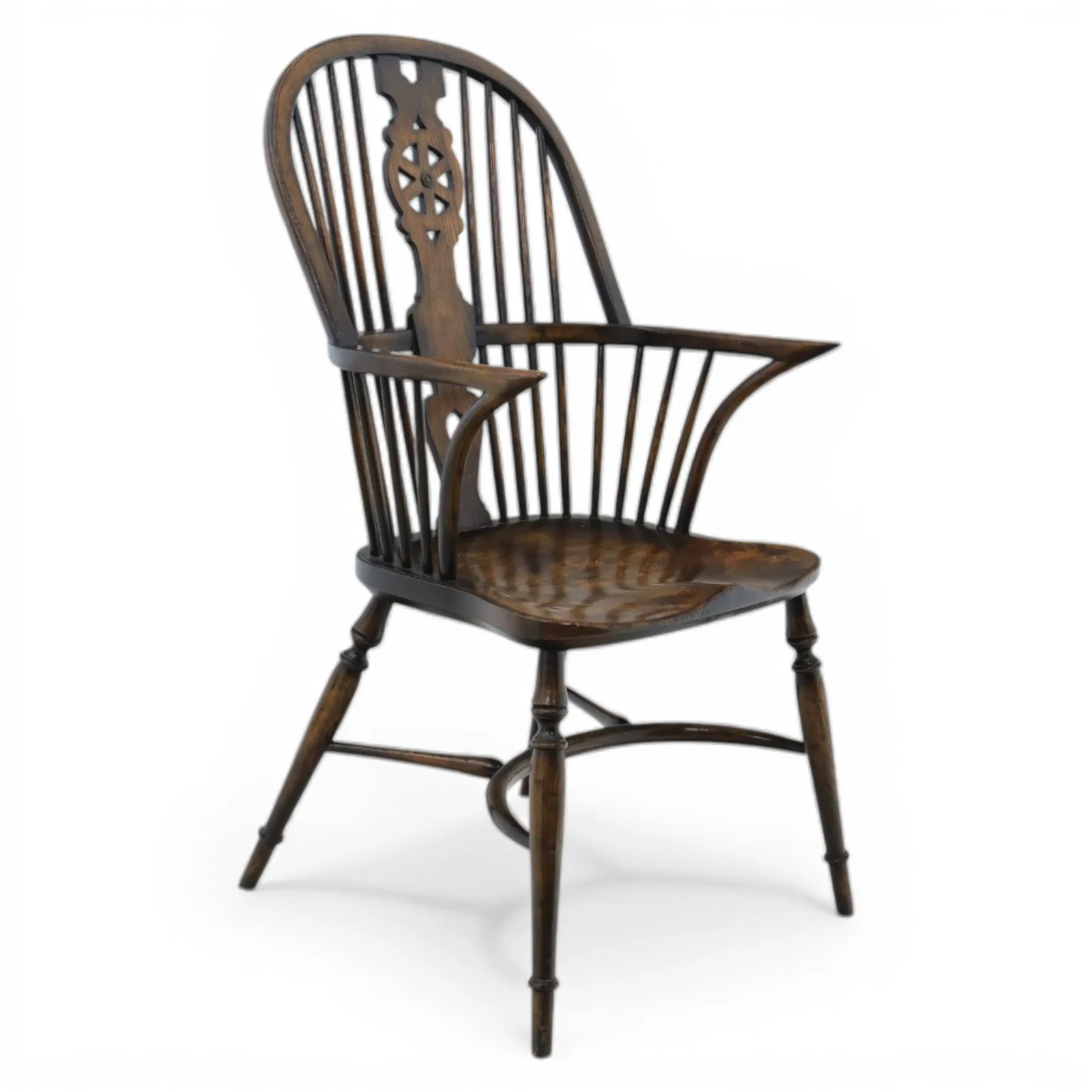Late 19th-century Edwardian English high-back Windsor armchair in elm and beech, the arched hoop back with pierced wheel and heart motifs, turned spindles and shaped arm rail, saddle seat, on turned legs joined by a crinoline stretcher - Plate 1