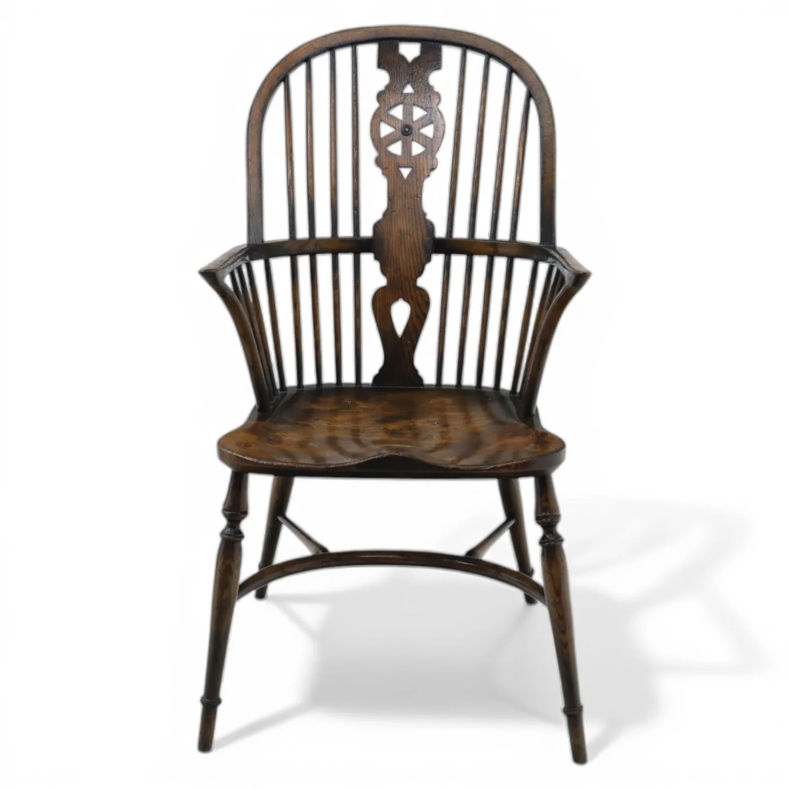 Late 19th-century Edwardian English high-back Windsor armchair in elm and beech, the arched hoop back with pierced wheel and heart motifs, turned spindles and shaped arm rail, saddle seat, on turned legs joined by a crinoline stretcher thumbnail 2