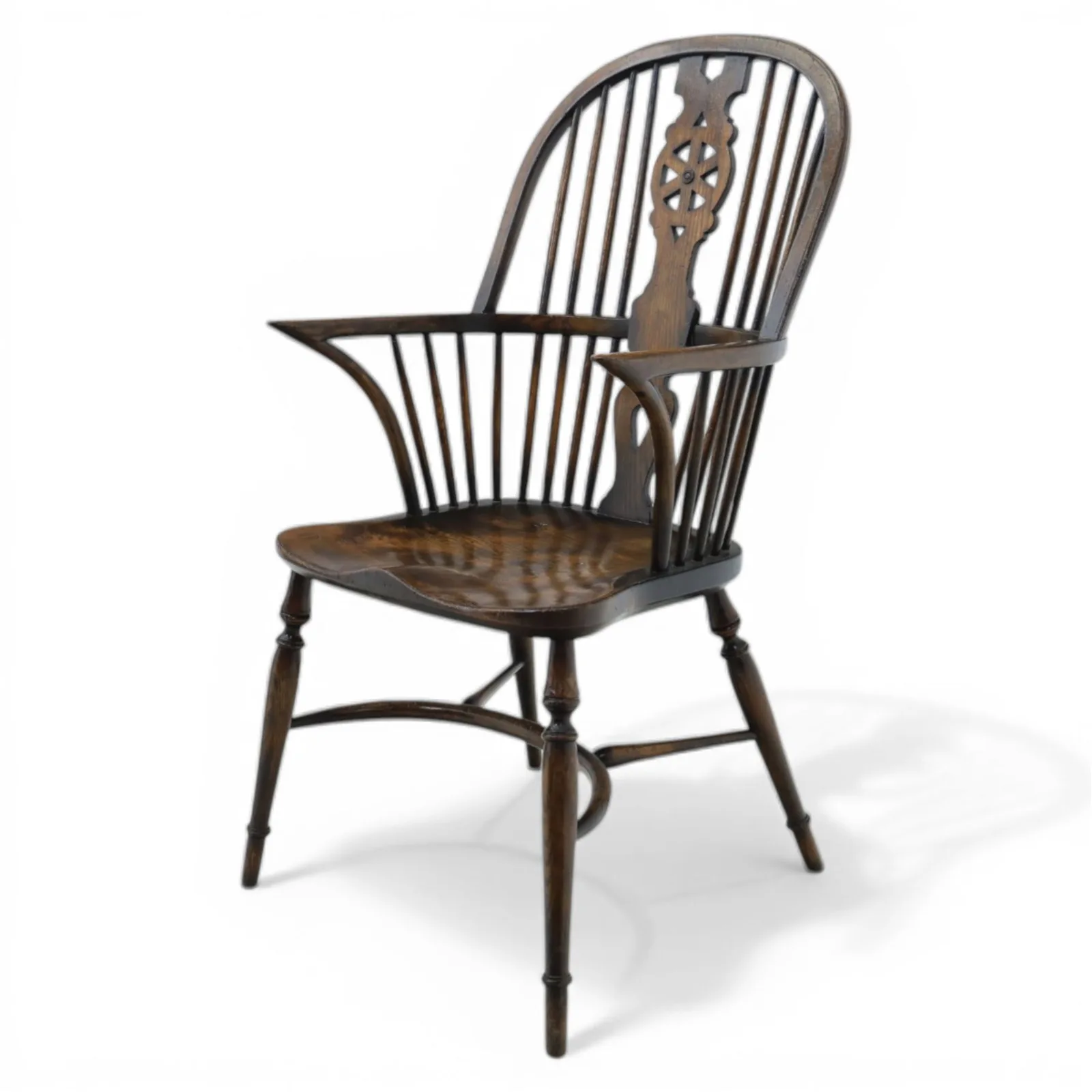 Late 19th-century Edwardian English high-back Windsor armchair in elm and beech, the arched hoop back with pierced wheel and heart motifs, turned spindles and shaped arm rail, saddle seat, on turned legs joined by a crinoline stretcher thumbnail 3