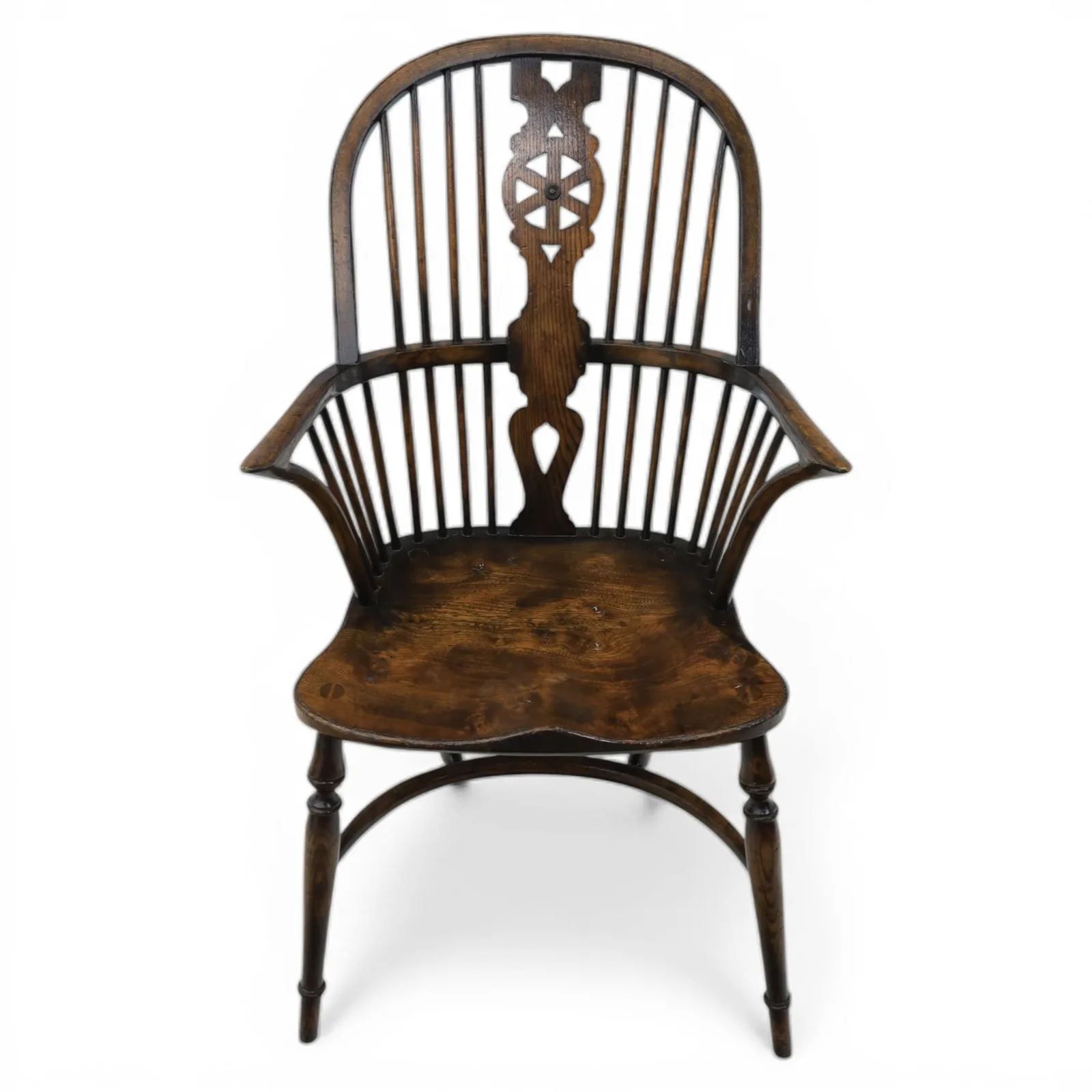 Late 19th-century Edwardian English high-back Windsor armchair in elm and beech, the arched hoop back with pierced wheel and heart motifs, turned spindles and shaped arm rail, saddle seat, on turned legs joined by a crinoline stretcher thumbnail 4
